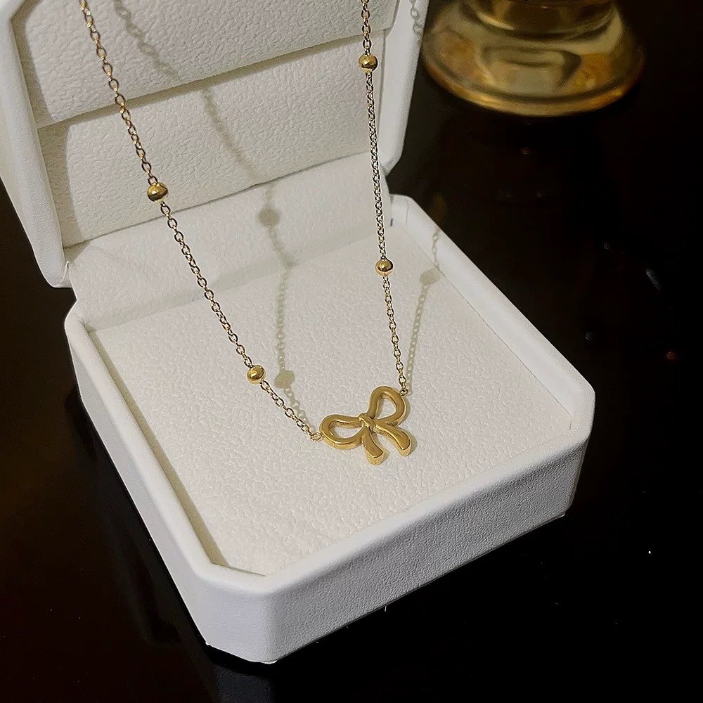 Cute gold tone bow necklace, stainless steel
